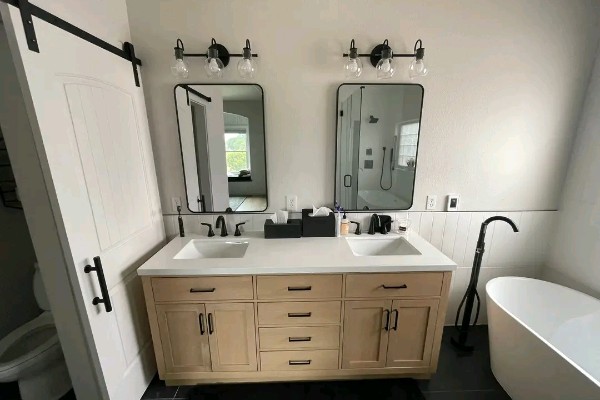 Modern bathroom with double vanity and premium plumbing installation, offering a clean, stylish, and relaxing space for everyday comfort.