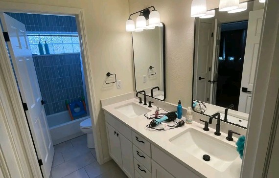 Elegant bathroom with double sink vanity and updated plumbing fixtures, designed for modern comfort and everyday relaxation.