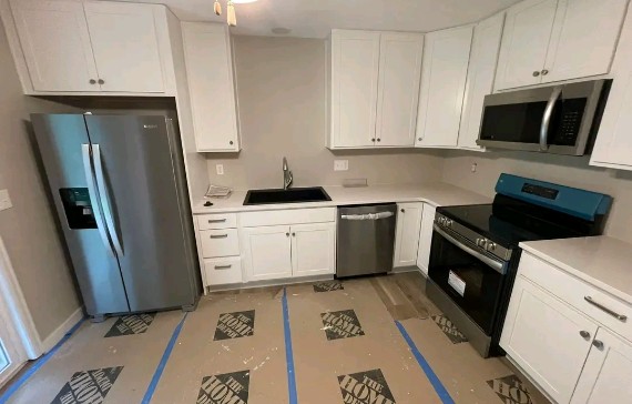 Modern kitchen with new plumbing installation, sleek white cabinets, stainless steel appliances, and a stylish layout ready for comfortable everyday cooking.